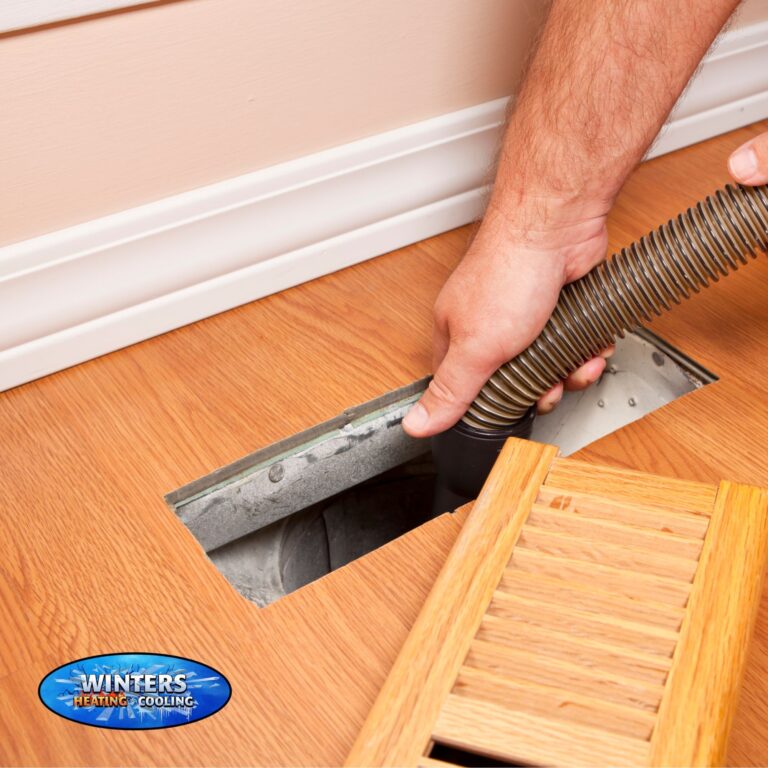 person cleaning out a home air duct