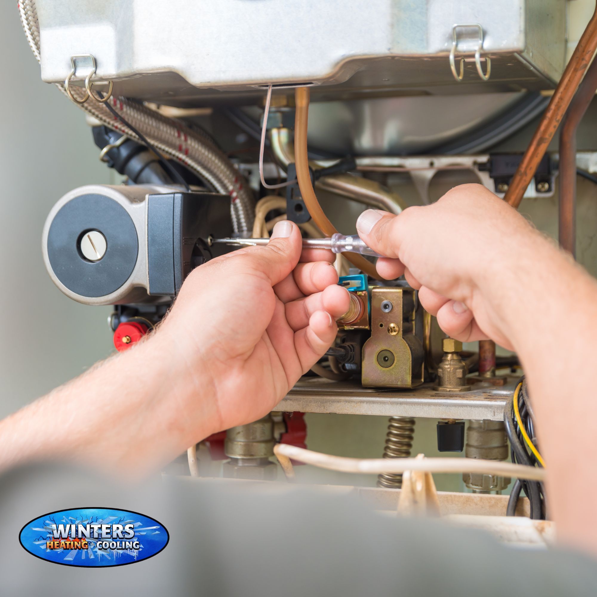 HVAC technician working on furnace