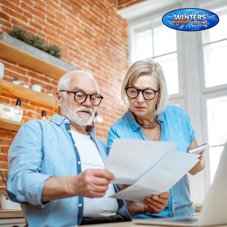 elderly couple looking at papers