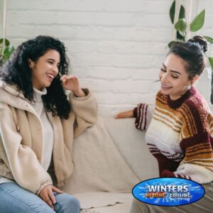 two women sitting on sofas