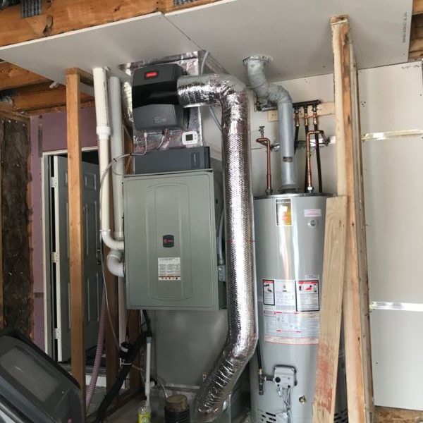 Installed HVAC system and water heater in a home's utility area.